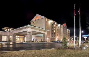 a hotel building with a parking lot at night at Hilton Garden Inn Valdosta in Valdosta