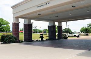 a gas station with columns and a parking lot at Hampton Inn and Suites Stephenville in Stephenville