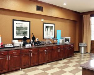 a lobby with a large counter with wooden cabinets at Hampton Inn and Suites Stephenville in Stephenville