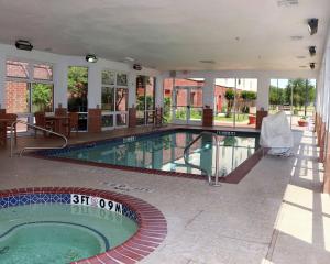 a large swimming pool in a building with a pool at Hampton Inn and Suites Stephenville in Stephenville