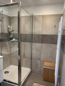 a shower with a glass door in a bathroom at Le Californie YourHostHelper in Nice