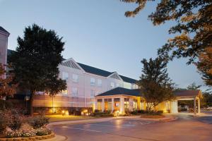 a large building with a parking lot in front of it at Hilton Garden Inn Bentonville Rogers in Bentonville