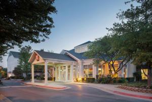 a hotel with a large building on a street at Hilton Garden Inn Bentonville Rogers in Bentonville