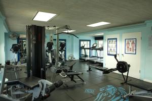 a gym with several tread machines in a room at Spinnaker, #127 Port St. Charles Marina, Speightstown - Waterfront Luxury in Saint Peter