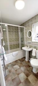 a bathroom with a shower and a sink and a toilet at 9 The Downs, Thurlestone, South Devon on the coastal footpath overlooking Burgh Island in Thurlestone