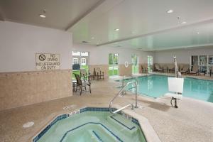 a pool with a hot tub in a hotel room at Homewood Suites by Hilton Portland in Scarborough