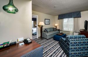 a living room with a couch and a chair at Homewood Suites by Hilton Portland in Scarborough