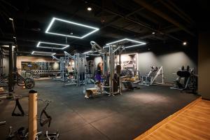 a gym with a person exercising in the gym at Hotel 53° Nord in Brake