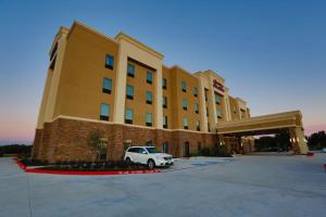 a white car parked in front of a hotel at Hampton Inn and Suites Missouri City in Missouri City