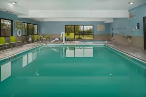 a swimming pool with blue water in a building at Hampton Inn Shelbyville in Shelbyville