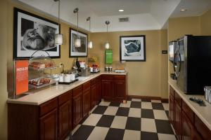 a large kitchen with a counter and a checkered floor at Hampton Inn Shelbyville in Shelbyville