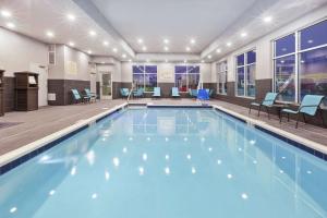 a swimming pool with blue water in a building at Hampton Inn Sedalia in Sedalia