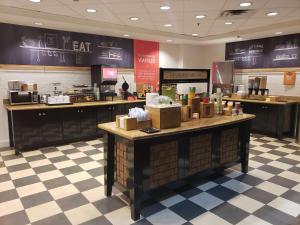 a restaurant with a counter with boxes on it at Hampton Inn & Suites Palestine in Palestine