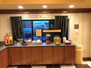 a restaurant with a counter with food on it at Hampton Inn Seaford in Seaford