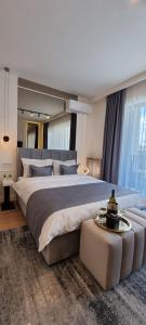 a large bedroom with a large bed and a couch at Beograd na vodi - BW Terra Exclusive in Belgrade