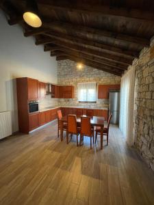 a kitchen with a table and chairs in a room at Villa Maria 2 in Gliki