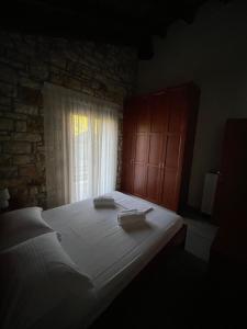 a bedroom with a large bed and a window at Villa Maria 3 in Gliki