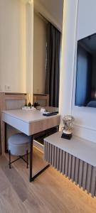 a room with a white table and a television at Beograd na vodi - BW Terra Exclusive in Belgrade +58 photos