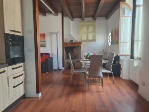 a kitchen and dining room with a table and chairs at La Casetta Di Alfonso in Santa Marinella