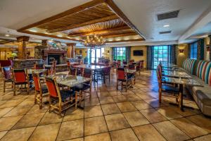a restaurant with tables and chairs and a chandelier at Hampton Inn Kayenta Monument Valley in Kayenta