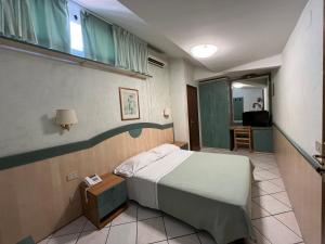 a hospital room with a bed and a window at Hotel Villa Primavera in Pisa