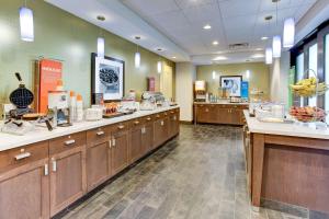 a cafeteria with wooden cabinets and bananas on display at Hampton Inn & Suites Manchester, TN in Manchester