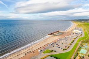 an aerial view of a beach and the ocean at Prestwick Pink Pad in Prestwick