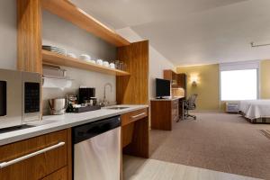 a kitchen with a sink and a microwave in a room at Home2 Suites by Hilton Denver West / Federal Center in Lakewood