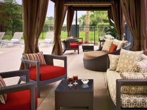 a patio with couches and chairs and a table at DoubleTree Hotel & Suites Charleston Airport in Charleston