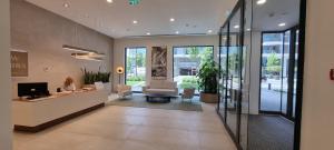 an office lobby with a reception desk and chairs at Beograd na vodi - BW Terra Exclusive in Belgrade