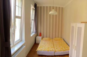 A bed or beds in a room at Apartment Sopot I