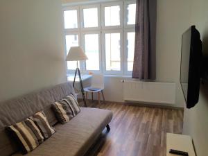 a living room with a couch and a window at Apartment Sopot I in Sopot