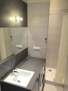 a bathroom with a sink and a mirror at Apartment Sopot I in Sopot +10 photos
