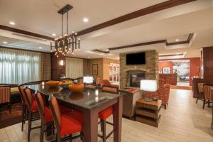 a dining room and living room with a dining table at Hampton Inn Kingston in Kingston
