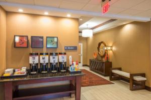 a waiting room at a hospital with a counter with alcohol bottles at Hampton Inn Kingston in Kingston
