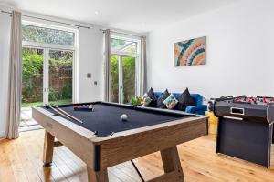 a living room with a pool table and a couch at Bermondsey Guest House in London