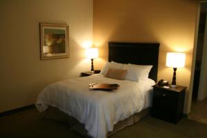a hotel room with a bed with a tray on it at Hampton Inn La Grange in La Grange