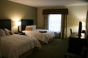 a hotel room with two beds and a window at Hampton Inn La Grange in La Grange