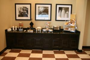 a room with a dresser with many items on it at Hampton Inn La Grange in La Grange