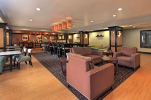 a lobby with chairs and tables and a bar at Hampton Inn Defiance in Defiance