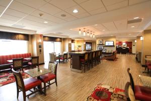 a lobby of a hotel with tables and chairs at Hampton Inn - Atmore in Atmore
