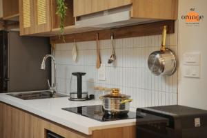 a kitchen with a stove with a pot on the counter at iRest Orange Tay Ho Lakeside Apartment in Hanoi