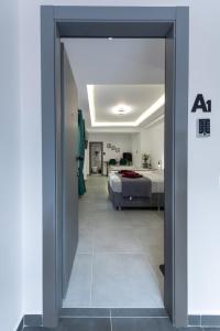 a door leading to a bedroom with a bed at Frourio Lodge Α1 in Larisa