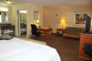 a hotel room with a bed and a couch and a desk at Hampton Inn Clinton in Clinton +13 photos