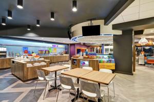 a restaurant with tables and chairs and a food court at Tru By Hilton Richmond in Richmond