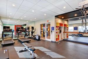 a gym with several treadmills and machines in a room at Tru By Hilton Richmond in Richmond