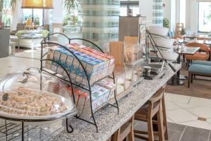 a buffet of food on a counter in a restaurant at Hilton Garden Inn Plymouth in Plymouth