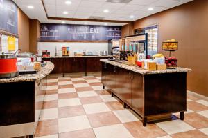 a fast food restaurant with a counter with food at Hampton Inn and Suites Bakersfield / Highway 58 in Bakersfield