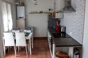a kitchen with a counter and a table and chairs at [Terrazza privata] Venezia Mestre in Marghera