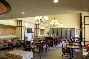 a dining room with tables and chairs and chandeliers at Hampton Inn & Suites Dallas-Arlington North-Entertainment District in Arlington